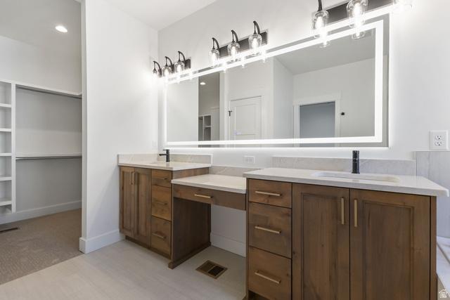 638 East Mountain Road North Ogden, UT 84414 - Photo 15 of 28 Bathroom featuring double vanity, a walk in closet, and light colored carpet