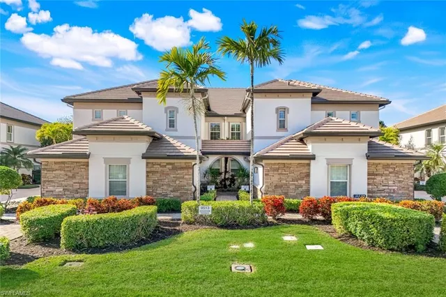 a front view of a house with a garden and plants