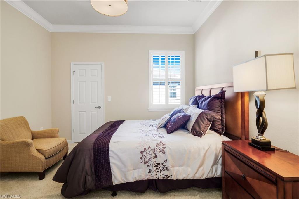 9513 Ironstone Terrace, Unit 202 Naples, FL 34120 - Photo 22 of 47 a bedroom with a bed and a window