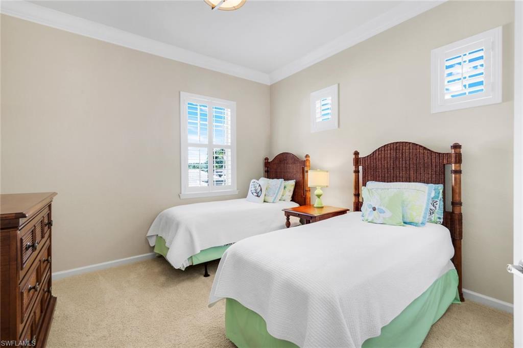 9513 Ironstone Terrace, Unit 202 Naples, FL 34120 - Photo 24 of 47 a bedroom with two beds and a window