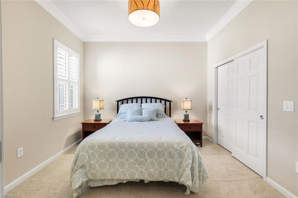 9513 Ironstone Terrace, Unit 202 Naples, FL 34120 - Photo 26 of 47 a bedroom with a bed and window