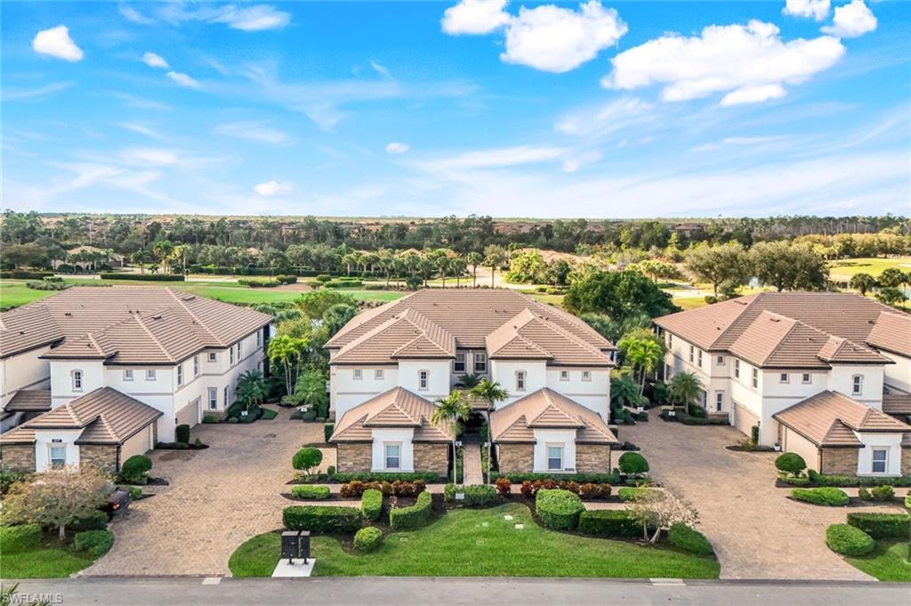 9513 Ironstone Terrace, Unit 202 Naples, FL 34120 - Photo 3 of 47 a view of multiple houses with a city view