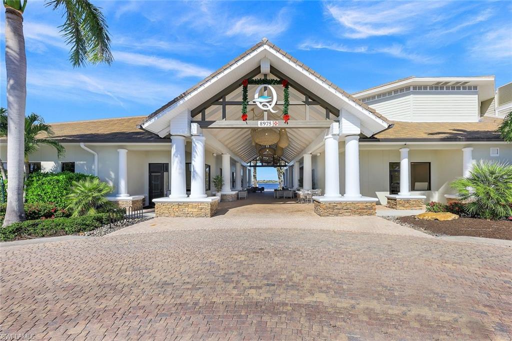 9513 Ironstone Terrace, Unit 202 Naples, FL 34120 - Photo 33 of 47 a view of a house with a patio and a yard