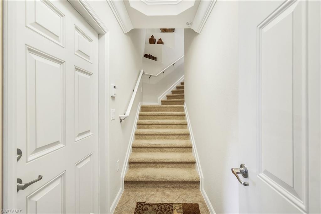 9513 Ironstone Terrace, Unit 202 Naples, FL 34120 - Photo 4 of 47 a view of staircase with white walls