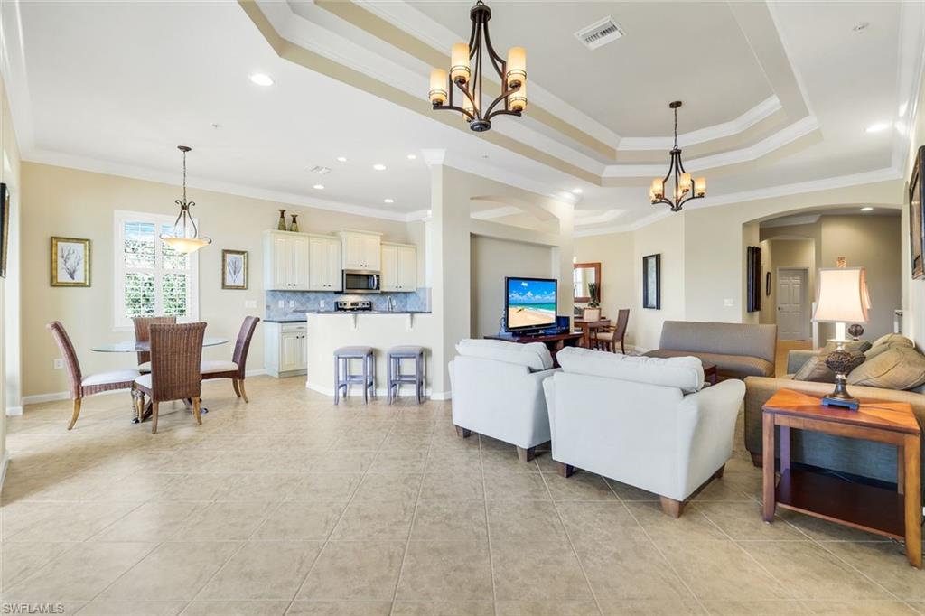 9513 Ironstone Terrace, Unit 202 Naples, FL 34120 - Photo 5 of 47 a living room with furniture and kitchen view