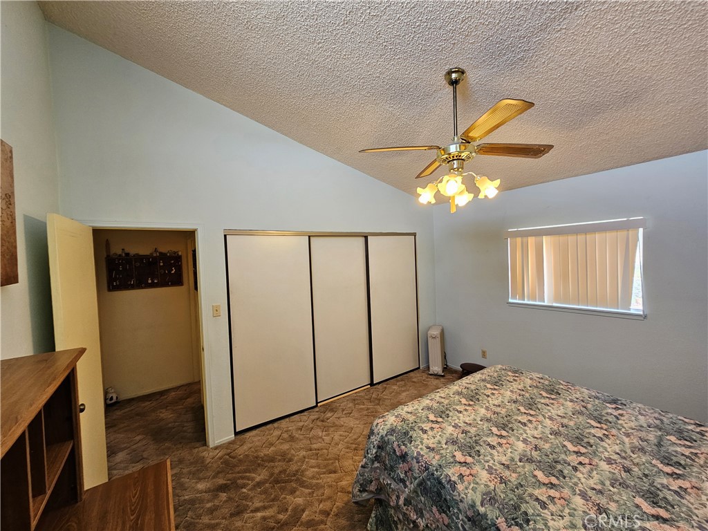 5566 Oleta Road Johnson Valley, CA 92285 - Photo 21 of 48 a bedroom with a bed and a chandelier