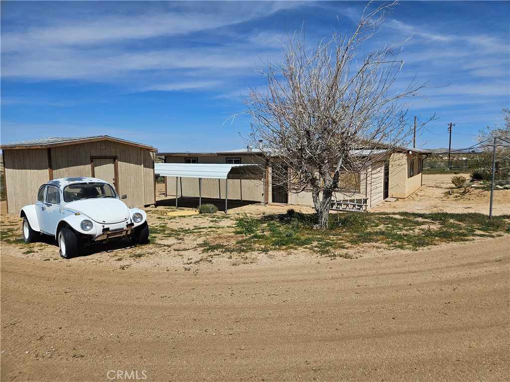 5566 Oleta Road Johnson Valley, CA 92285 - Photo 35 of 48 a front view of a house with garden