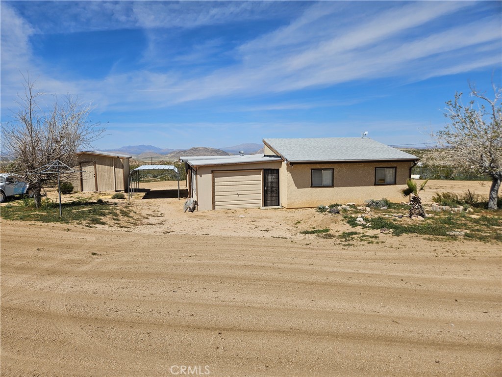 5566 Oleta Road Johnson Valley, CA 92285 - Photo 9 of 48 a front view of a house with a yard