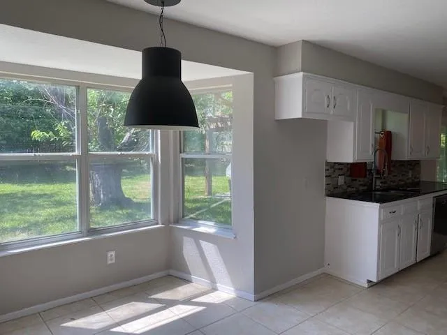 a kitchen with a large window cabinets and stainless steel appliances