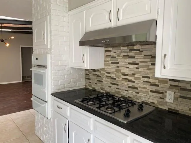 a kitchen with a stove and a sink