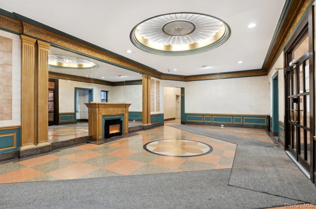 76-12 35th Avenue, Unit 1B Queens, NY 11372 - Photo 2 of 22 Lobby with recessed lighting, crown molding, wainscoting, and a decorative wall