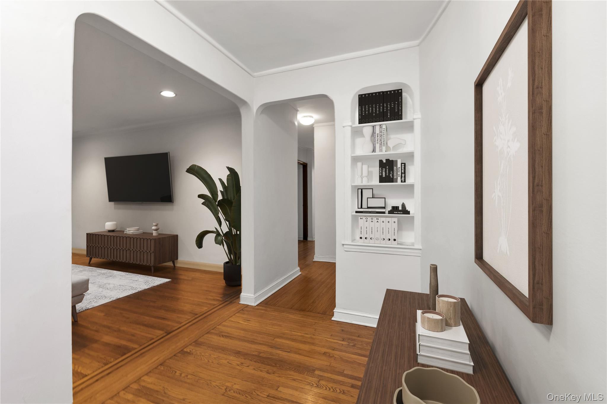 76-12 35th Avenue, Unit 1B Queens, NY 11372 - Photo 3 of 22 Hall with arched walkways, built in shelves, dark wood finished floors, and recessed lighting