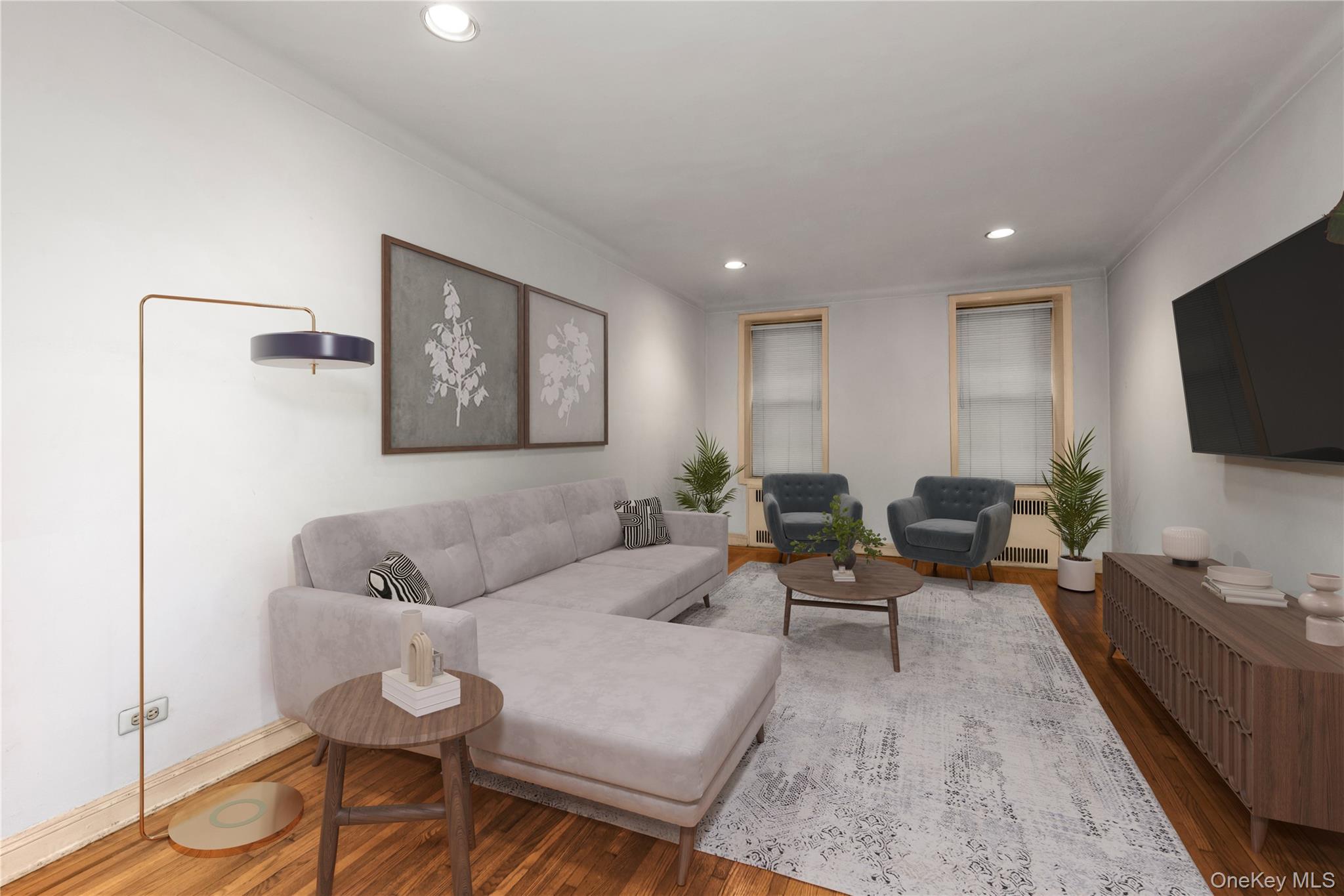 76-12 35th Avenue, Unit 1B Queens, NY 11372 - Photo 5 of 22 Living area with wood finished floors, recessed lighting, radiator heating unit, and crown molding