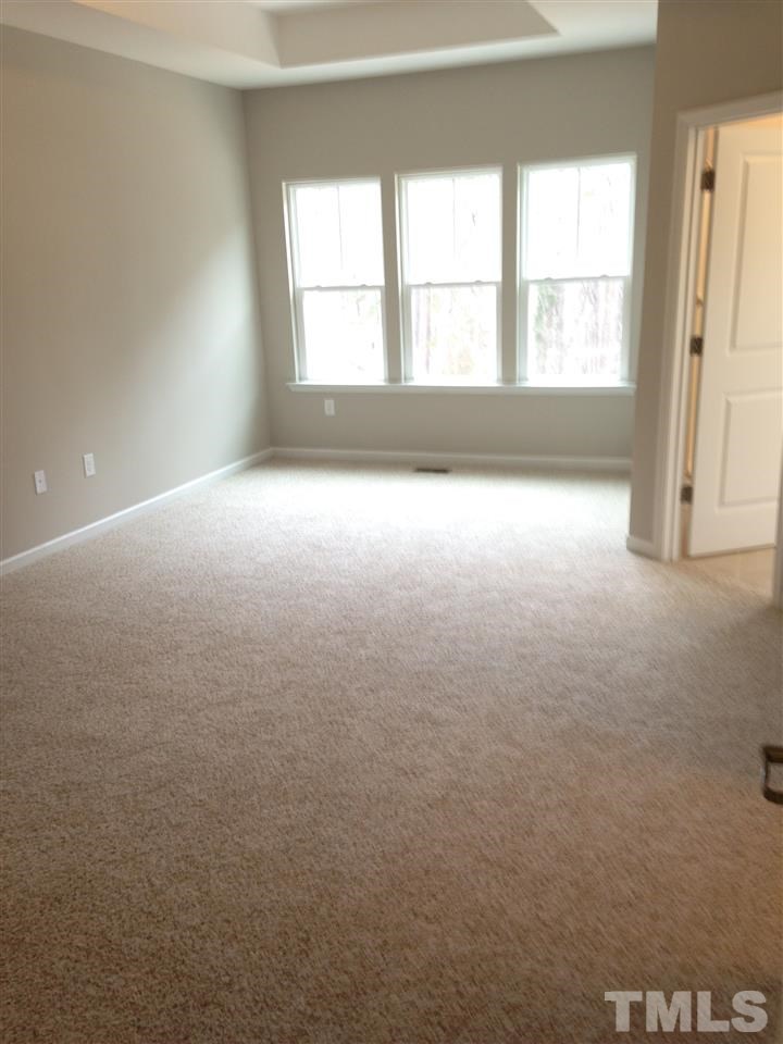702 Edgewater Ridge Court Apex, NC 27523 - Photo 10 of 21 Master bedroom with sitting area and 10 ft. trey ceiling.