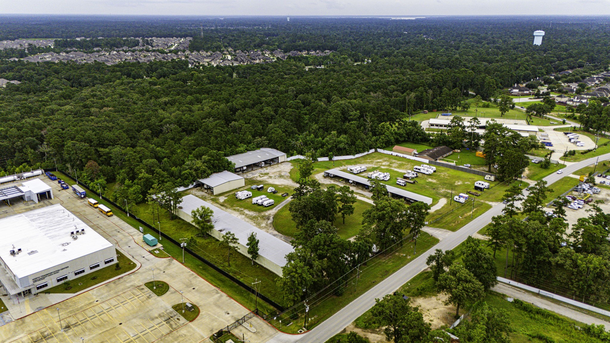 an aerial view of a residential houses with yard