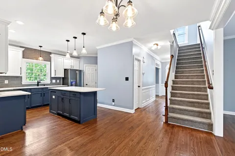 a kitchen with stainless steel appliances a stove sink microwave and cabinets