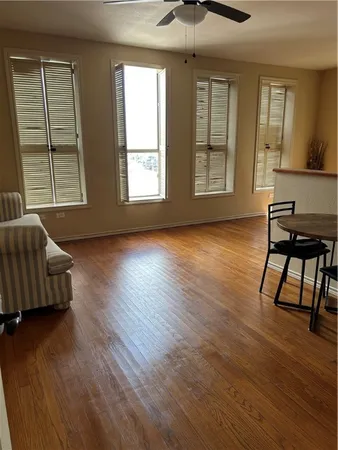 a view of room with window and wooden floor