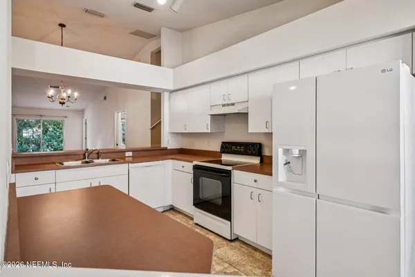 a kitchen with stainless steel appliances a stove a sink and a refrigerator