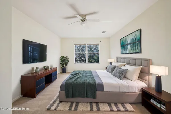 a bedroom with a bed and a flat screen tv