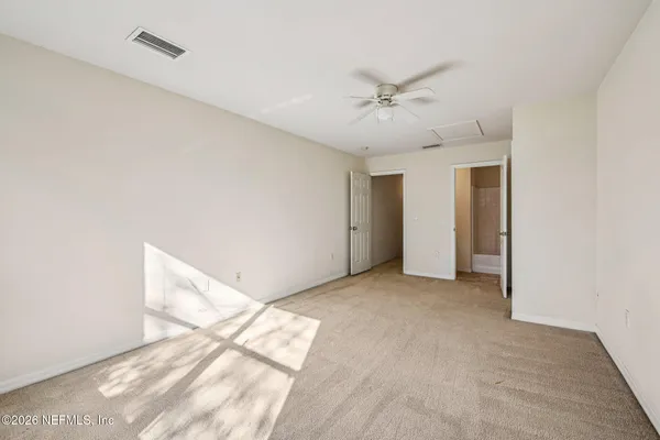a view of an empty room with a ceiling fan