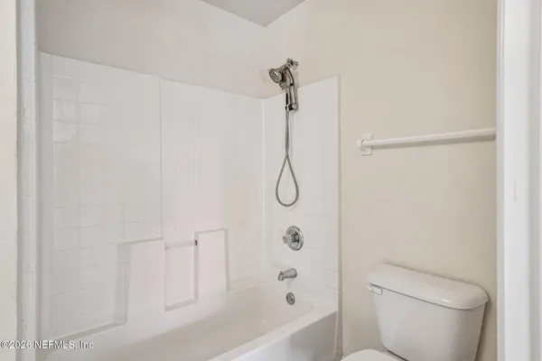 a bathroom with a toilet and shower