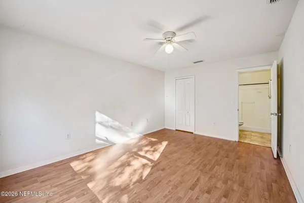 a view of empty room with wooden floor