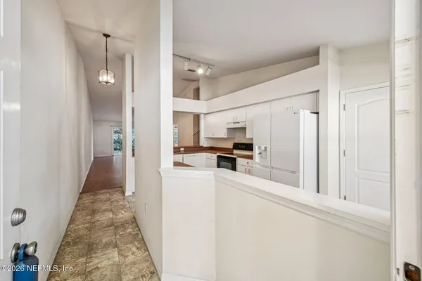 a view of a kitchen from the hallway