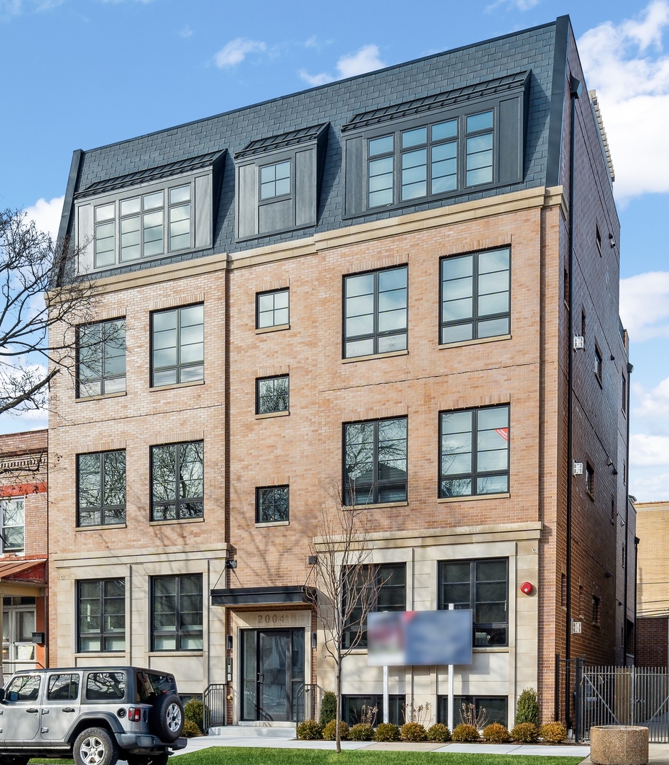 a front view of a building with a lot of windows