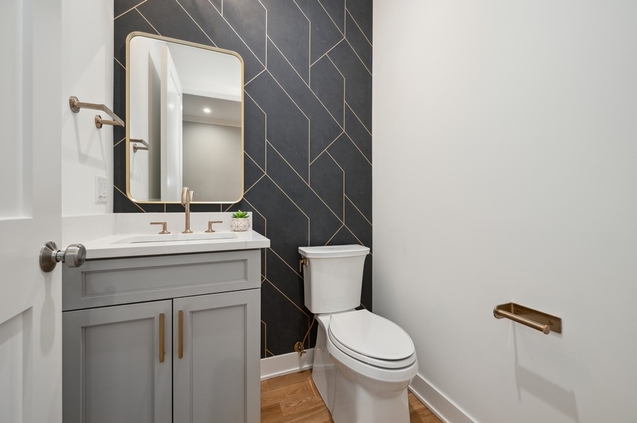 2004 West Addison Street, Unit 1E Chicago, IL 60618 - Photo 13 of 27 a bathroom with a sink toilet and mirror