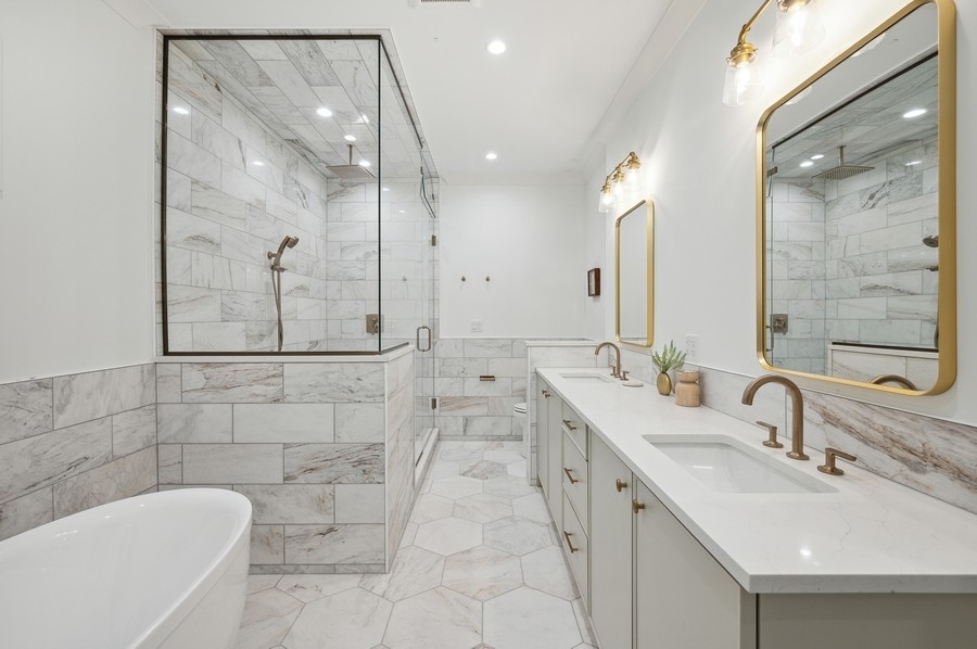 2004 West Addison Street, Unit 1E Chicago, IL 60618 - Photo 16 of 27 a bathroom with a double vanity sink mirror and bathtub