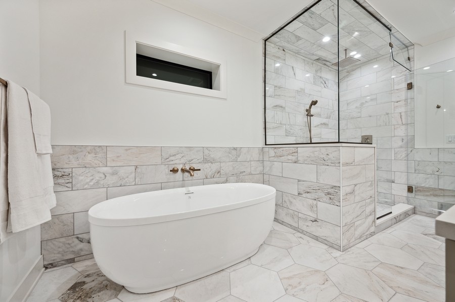 2004 West Addison Street, Unit 1E Chicago, IL 60618 - Photo 18 of 27 a white bath tub sitting in a bathroom and bathroom