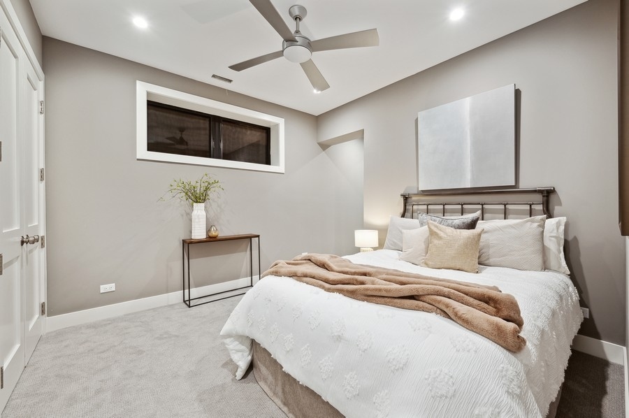 2004 West Addison Street, Unit 1E Chicago, IL 60618 - Photo 20 of 27 a bedroom with a bed and a flat screen tv