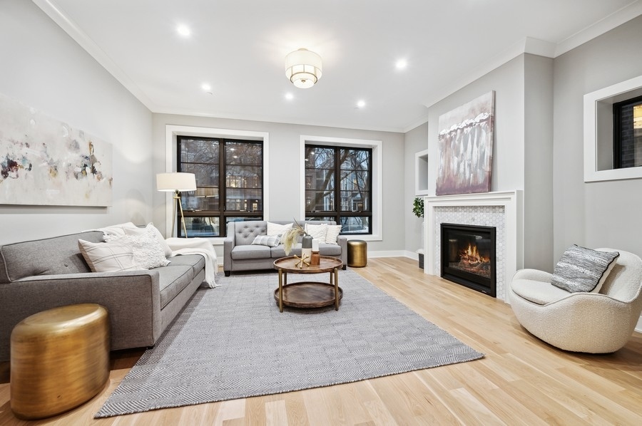 2004 West Addison Street, Unit 1E Chicago, IL 60618 - Photo 2 of 27 a living room with furniture and a fireplace