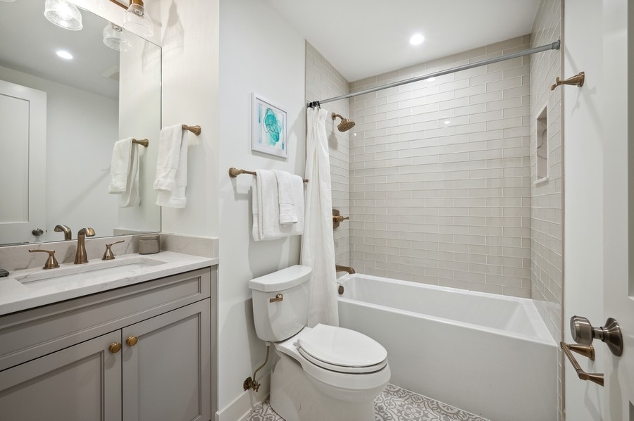 2004 West Addison Street, Unit 1E Chicago, IL 60618 - Photo 24 of 27 a bathroom with a sink a toilet and shower