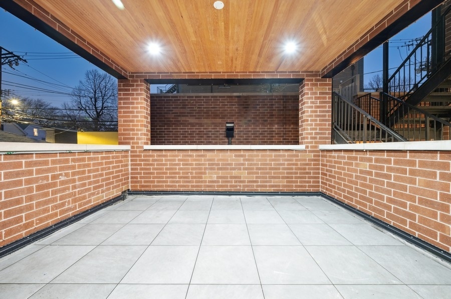 2004 West Addison Street, Unit 1E Chicago, IL 60618 - Photo 26 of 27 a view of a brick wall with windows