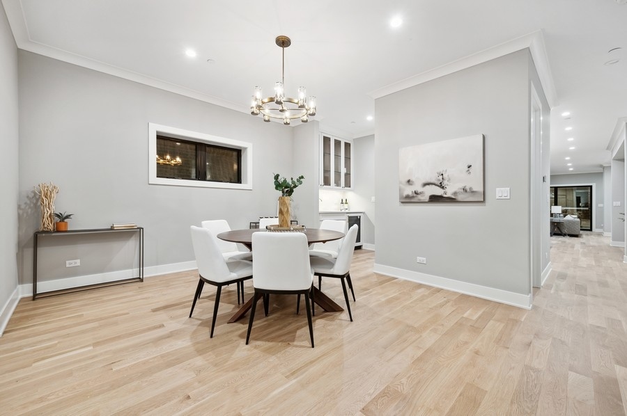 2004 West Addison Street, Unit 1E Chicago, IL 60618 - Photo 4 of 27 a view of a dining room with furniture and wooden floor