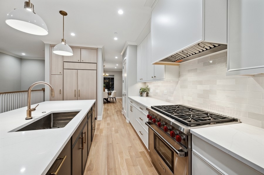 2004 West Addison Street, Unit 1E Chicago, IL 60618 - Photo 9 of 27 a kitchen with kitchen island a sink and stove