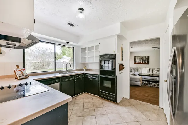 a kitchen with a refrigerator sink and stove