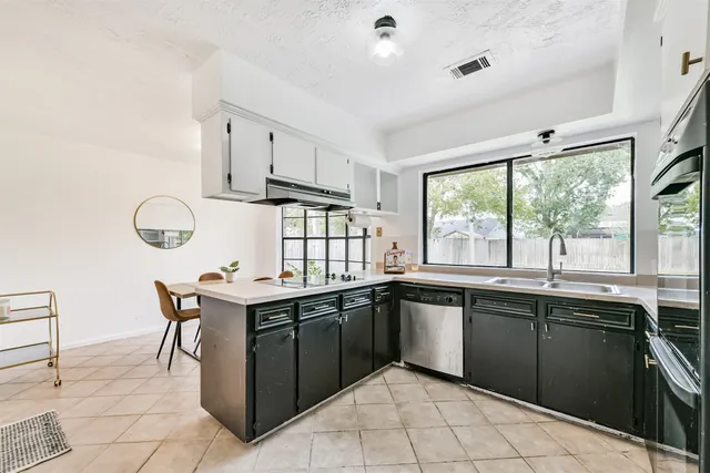 a dining room with furniture and a window