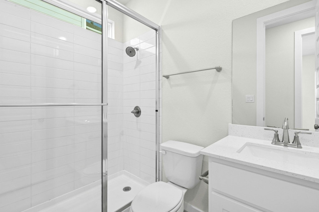 4733 Pleasant Place Round Rock, TX 78665 - Photo 18 of 33 a bathroom with a granite countertop sink toilet and shower