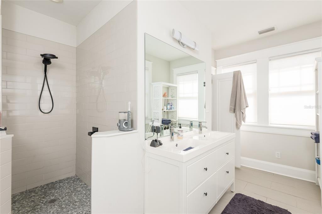 705 West Alfred Street Tampa, FL 33603 - Photo 19 of 25 a bathroom with a double vanity sink a mirror and shower