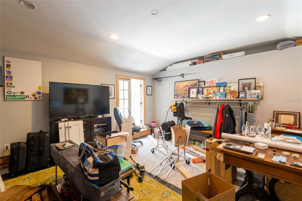 705 West Alfred Street Tampa, FL 33603 - Photo 22 of 25 a work room with furniture a rug and a flat screen tv