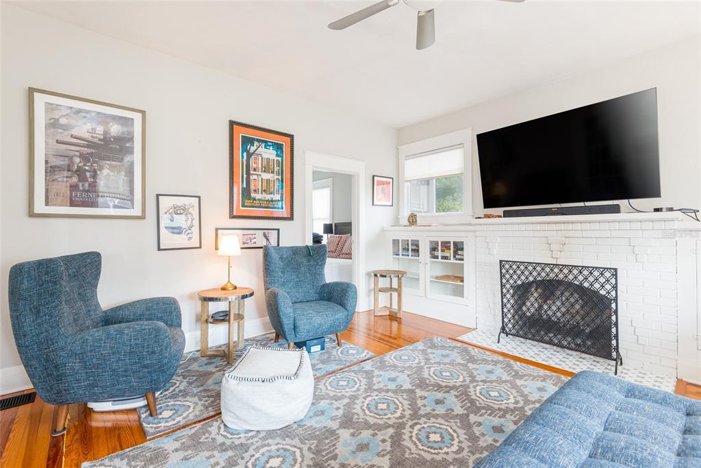 705 West Alfred Street Tampa, FL 33603 - Photo 6 of 25 a living room with furniture a flat screen tv and a fireplace