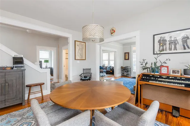 a living room with furniture and a dining table