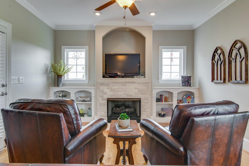 1219 White Rock Road Spring Hill, TN 37174 - Photo 12 of 30 a living room with furniture a flat screen tv and a fireplace