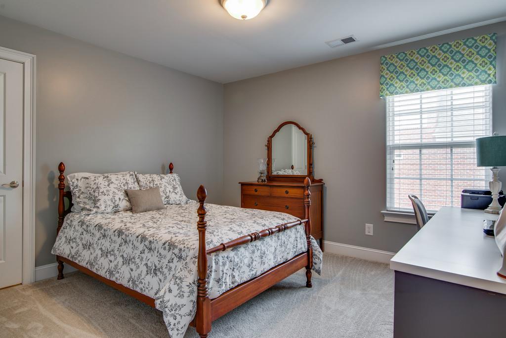 1219 White Rock Road Spring Hill, TN 37174 - Photo 21 of 30 a bedroom with a bed and a table