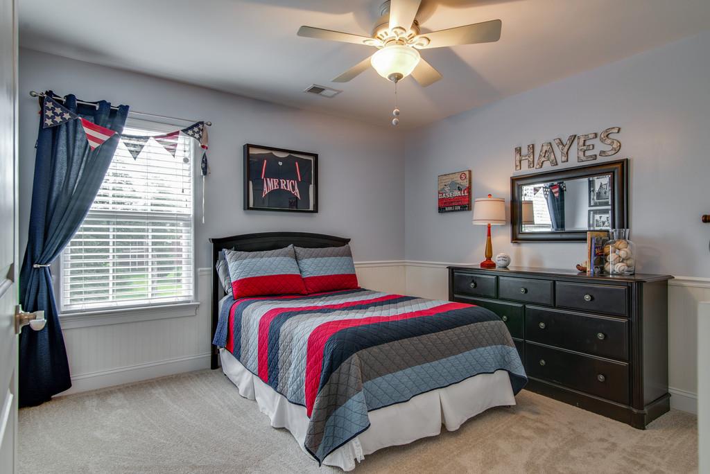 1219 White Rock Road Spring Hill, TN 37174 - Photo 24 of 30 a bedroom with a bed and a dresser