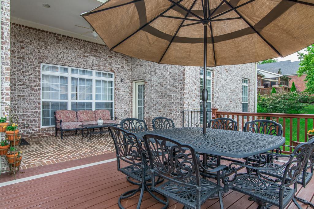 1219 White Rock Road Spring Hill, TN 37174 - Photo 28 of 30 a patio with a table and chairs under an umbrella