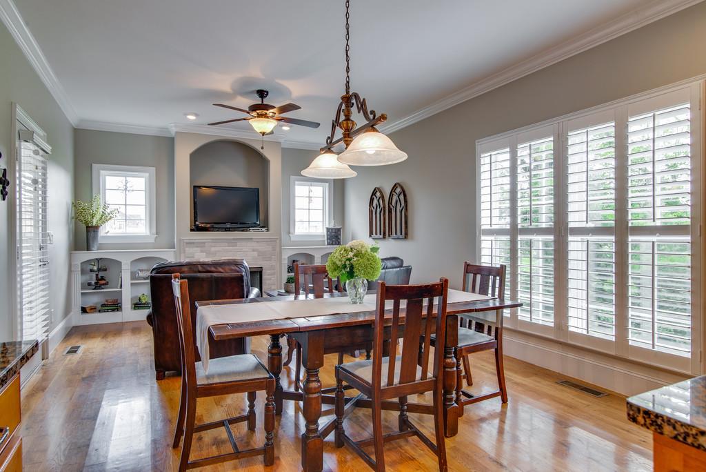 1219 White Rock Road Spring Hill, TN 37174 - Photo 10 of 30 a dining room with wooden floor a chandelier a wooden table and chairs