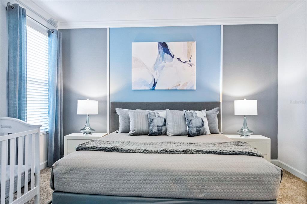 3032 Protagonist Street Kissimmee, FL 34746 - Photo 13 of 34 a bedroom with a bed and a painting on the wall